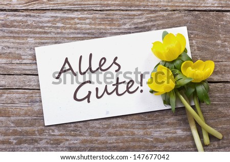 yellow flowers and white card with  lettering all the best/all the best/flowers