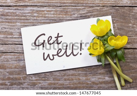 yellow flowers and white card with lettering get well/get well/flowers