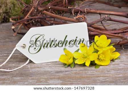 yellow blossoms and white card  with lettering voucher/lettering voucher/flowers