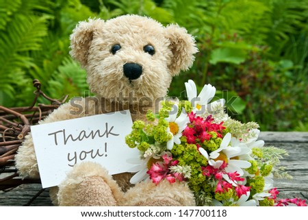 teddy bear with flowers and card with lettering thank you/thank you/teddy
