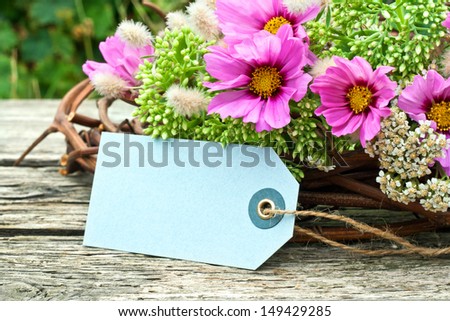 pink flowers with label on wooden ground/pink/flowers