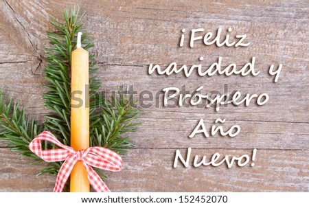 christmas card with fire and candle/Merry Christmas and a happy new year/spanish
