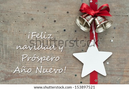 christmas card with red loop, bells and stars/Merry Christmas a happy new year/spanish