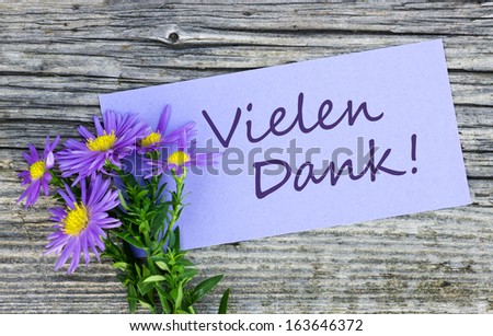 Violet flowers and card with lettering thank you/thank you/german