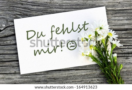 White card with white flowers/I miss you/german