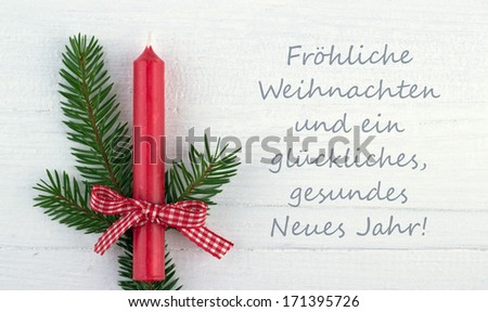 red candle, fire branch and christmas card/merry christmas and a happy New Year/german