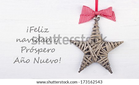 Christmas card with star/merry christmas and a happy new year/spanish
