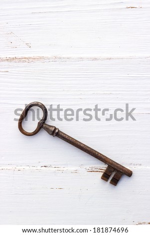 Old key on white wood /old key/wood