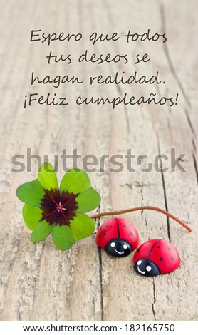 Birthday card with leafed clover and ladybugs/I hope all your wishes come true.Happy Birthday!/spanish