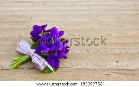 Bunch of violets on a wooden board/violets/bouquet