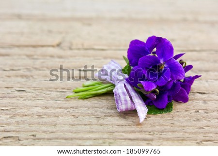 Bunch of violets on a wooden board/violets/bouquet