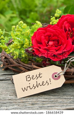 card with red roses and lettering Best wishes/Best wishes/english