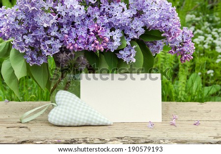 Bouquet of lilac with white card and heart/lilac/flowers