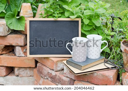 herbs with chalkboard, cup and books/herbs/garden