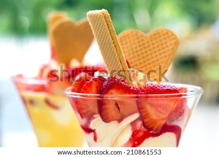 Double Scoop Of Fresh Strawberry Ice Cream In Waffle Cone Against