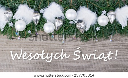 polish Christmas card with Pine green,  baubles and angel wings  and text Merry Christmas/Merry Christmas/polish