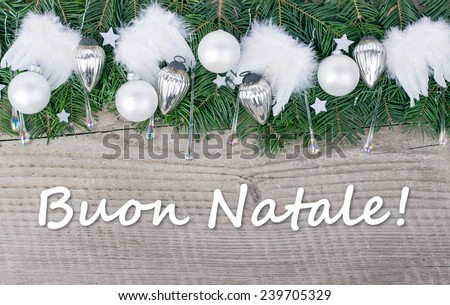 italian Christmas card with Pine green,  baubles and angel wings  and text Merry Christmas/Merry Christmas/italian