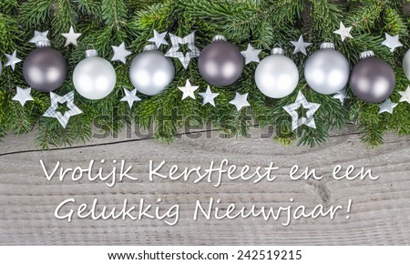 dutch Christmas card  with Christmas baubles, fir branches, stars and text Merry Christmas and a happy New Year/Merry Christmas and a happy New Year/dutch