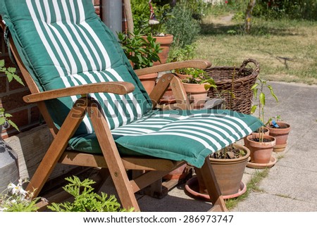 Outdoor chair and flower pots on the terrace / patio chair / garden