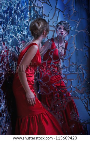 beautiful woman looking at the broken mirror