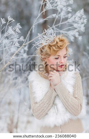 Portrait of beautiful woman in winter forest