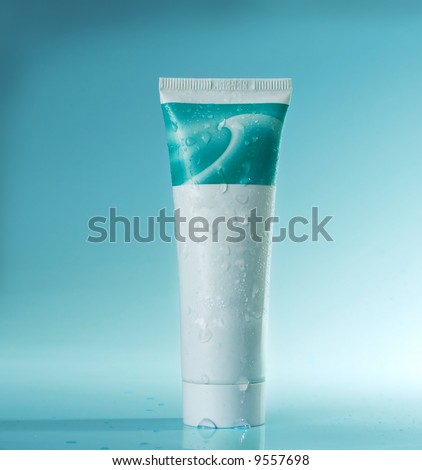close up of cosmetic tube on blue background