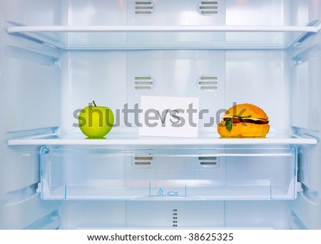 big sandwich and green apple in the empty white fridge