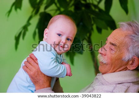 portrait of happy baby with old grandpa