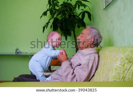 portrait of happy baby with old grandpa