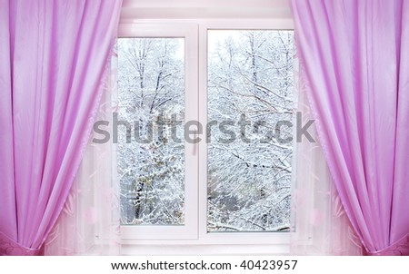 window with pink curtains and winter view behind it