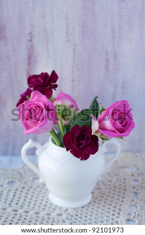 Bunch of roses in a white china vase