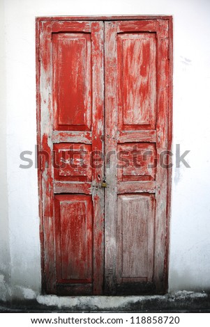 old red wooden door with metal key