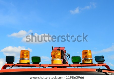 Closeup of fire truck top lights against blue sky background.