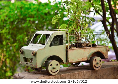handmade steel green car and small plant