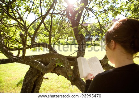 Woman reading a book in nature