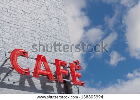 Red Cafe Sign Against Blue Sky