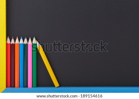 Colourful Drawing Pencils in Front of a Blackboard.Copy Space