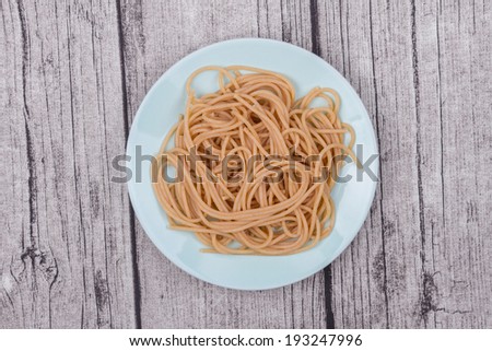 Cooked Whole Wheat Spaghetti on a Blue Plate