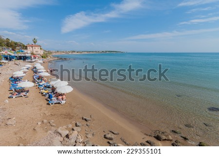 SIDE, TURKEY- OCTOBER 09, 2014: Beach of Side with Tourists, Sunbeds and Umbrellas on a Hot Summer Day on October 09,2014 in Side, Turkey