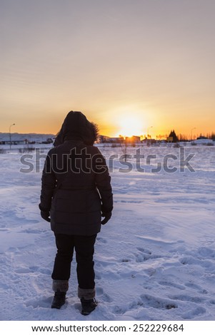 A Woman Watching Sunrise in Winter