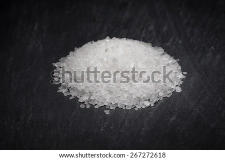 Creatively and Selectively Lit a Pinch of Rock Salt against a Black Background