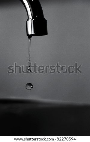 Dripping water from a tap in black and white colors