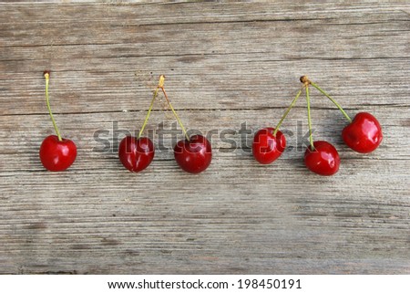 One, two, three,... Groups of cherries on wooden table
