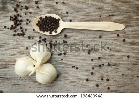 Garlic and pepper Garlic and black pepper  on the wooden table