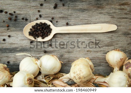 Garlic and pepper Garlic and black pepper  on the wooden table