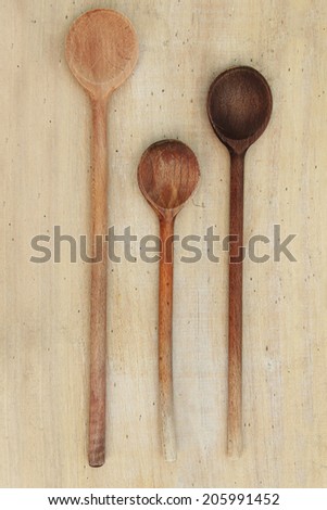 Wooden spoons Three wooden spoons lying on a table.
