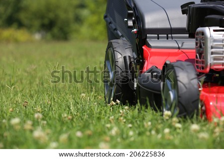 Mower Lawn mower on the grass during the summer day