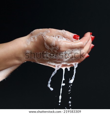 Washing hands Cleaning - woman washing hands on black background