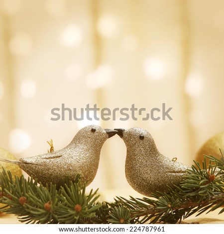 Golden shiny birds kissing on bokeh background