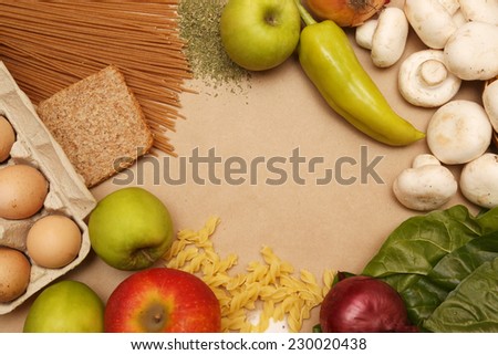 Creating a Recipe, Directly above view of blank paper surrounded by basic food ingredients. Add own text.